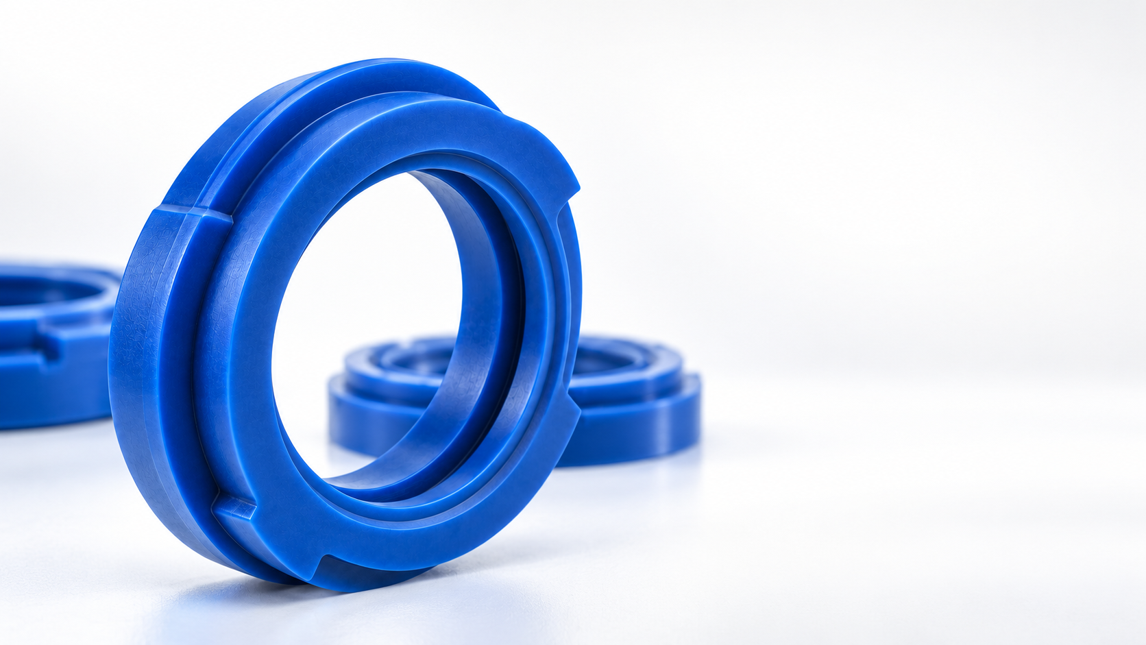 Blue custom moulded rubber seal with a stepped profile